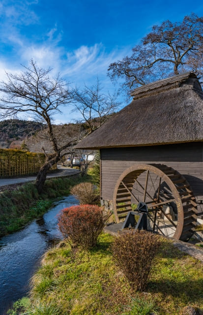 Oshino Hakkai watermill and river with blue sky
